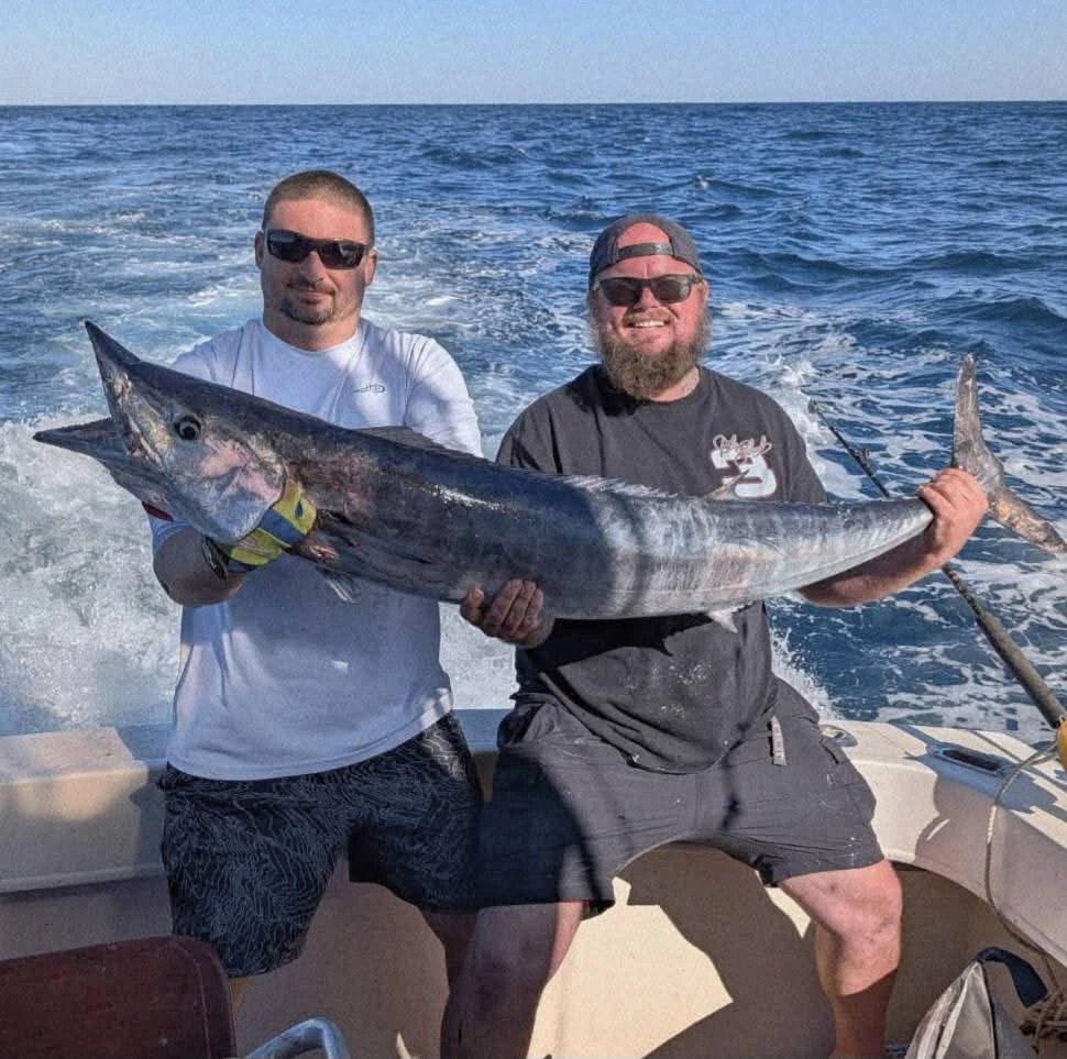 Crew with a wahoo boatside