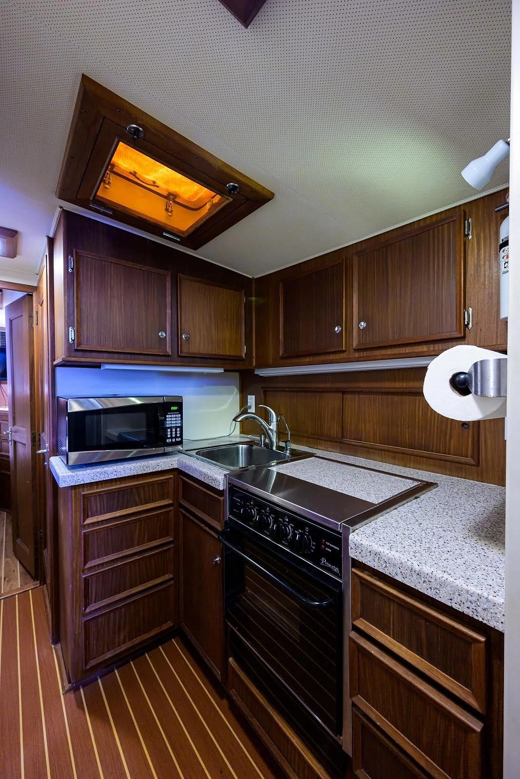 Below-deck galley with stove and fridge